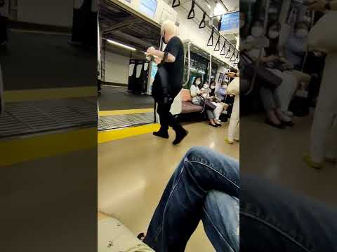 Japanese man tries to drag foreigner off the train for being loud and drinking.